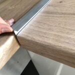 How to secure trim connecting two pieces of kitchen worktop .