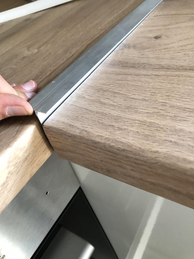 How to secure trim connecting two pieces of kitchen worktop .