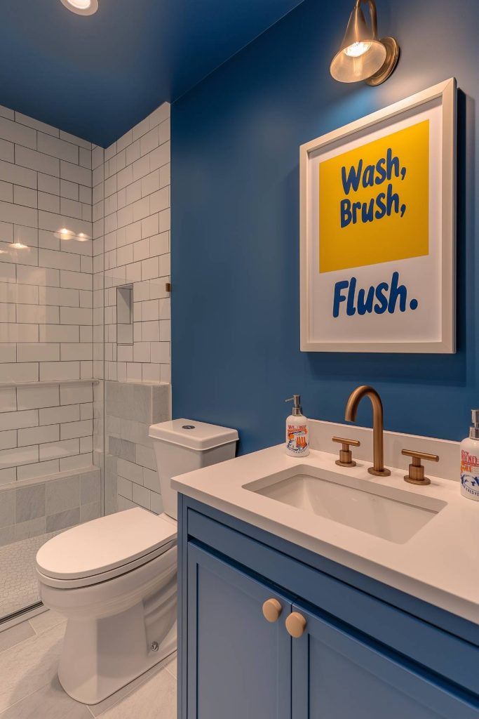 Modern bathroom with blue walls, a white vanity unit and a framed "Wash, brush, rinse" Sign.