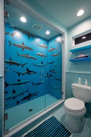 Bathroom with blue walls and a shark-themed shower.