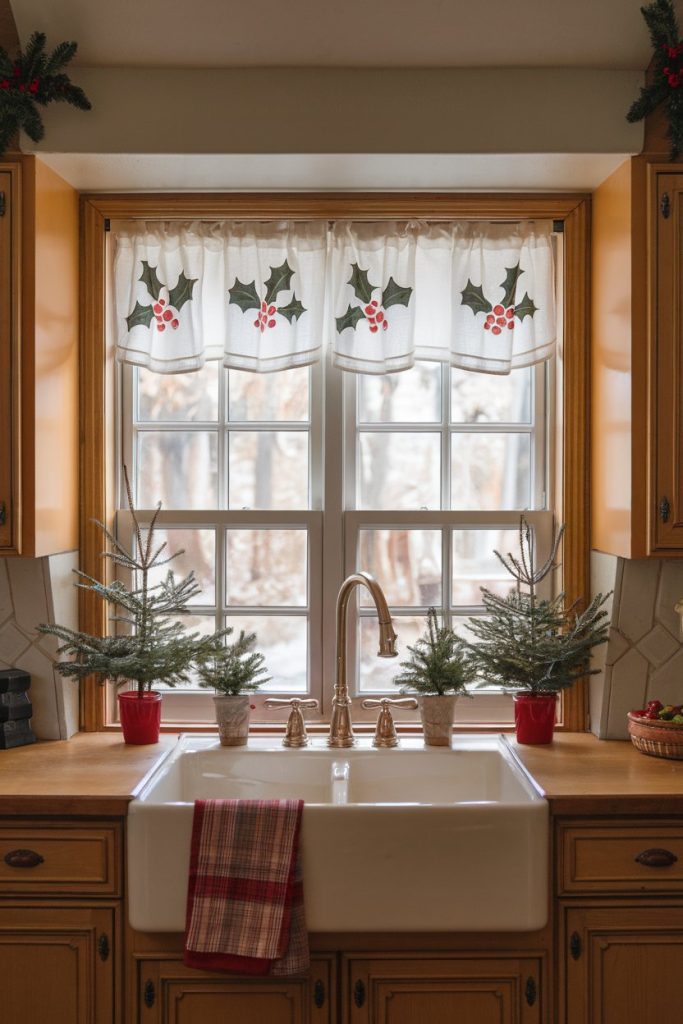 Kitchen sink with festive holly curtains, small pine trees in pots on the windowsill and a red checked towel over the sink.