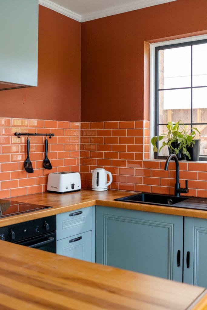 A kitchen with an orange tile backsplash, <a href=