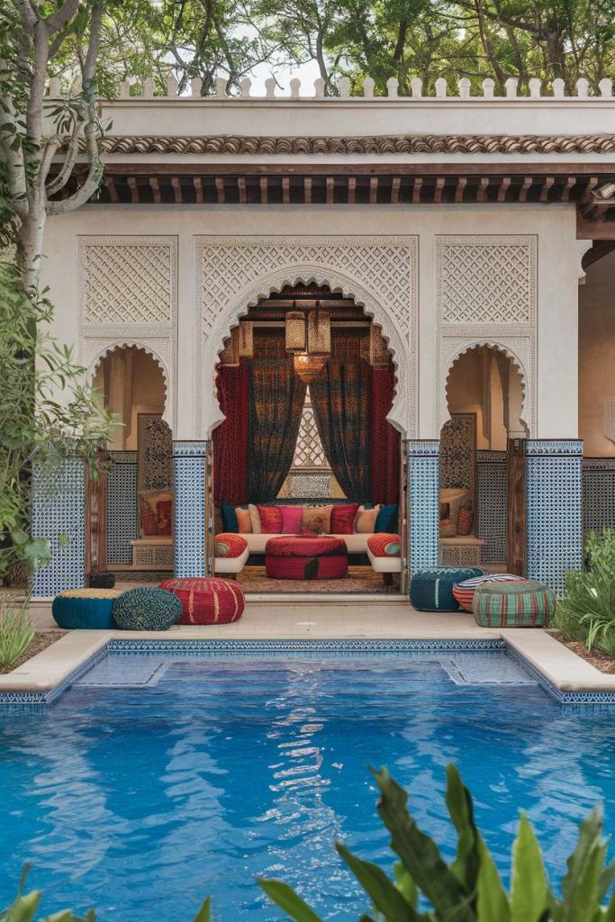 Luxurious pool area with intricate archways and colorful cushions framed by lush greenery and detailed tile work.