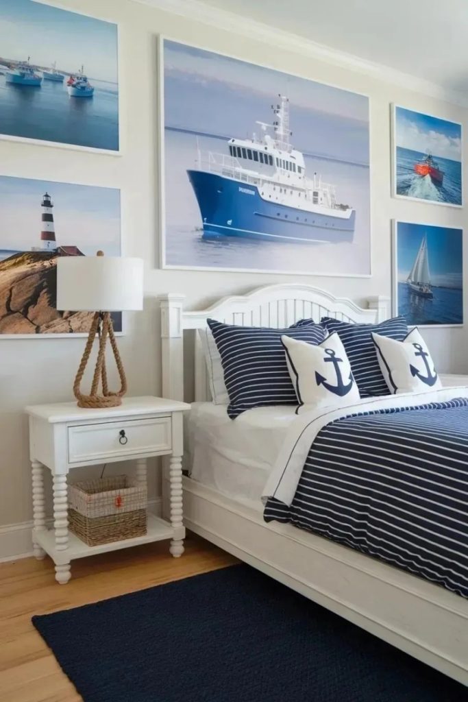 Bedroom with nautical decor, including ship-themed wall art and anchor-patterned bedding. White furniture complements the blue and navy color scheme.