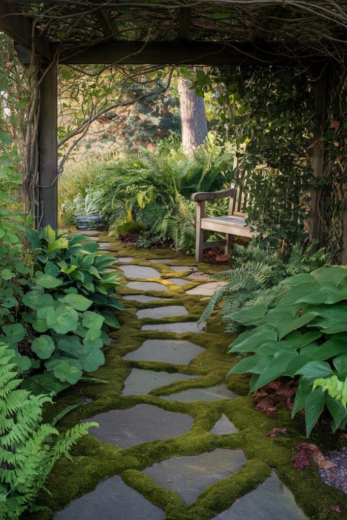 Stone path with moss leads to a wooden bench under an arbor surrounded by lush ferns and greenery.