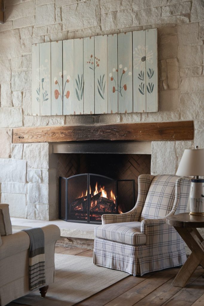 Cozy living room with a stone fireplace, a floral painting above, a checkered upholstered armchair and a burning fire.