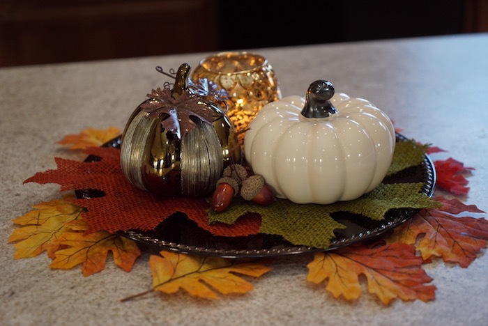 Autumn decor pumpkins with candle and leaves