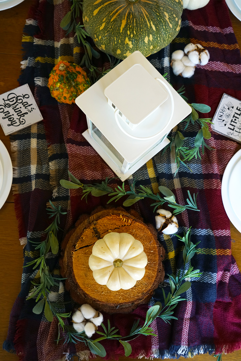 Wooden table with checkered ceiling and autumn decor