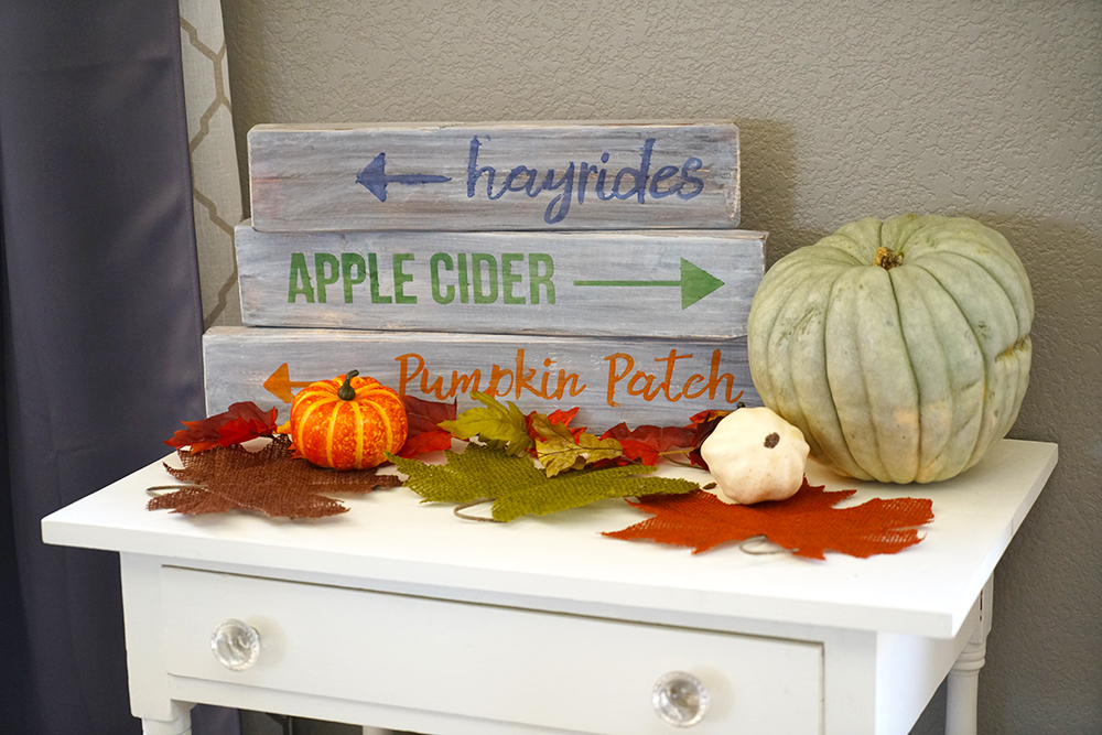 white table with wooden signs and pumpkins