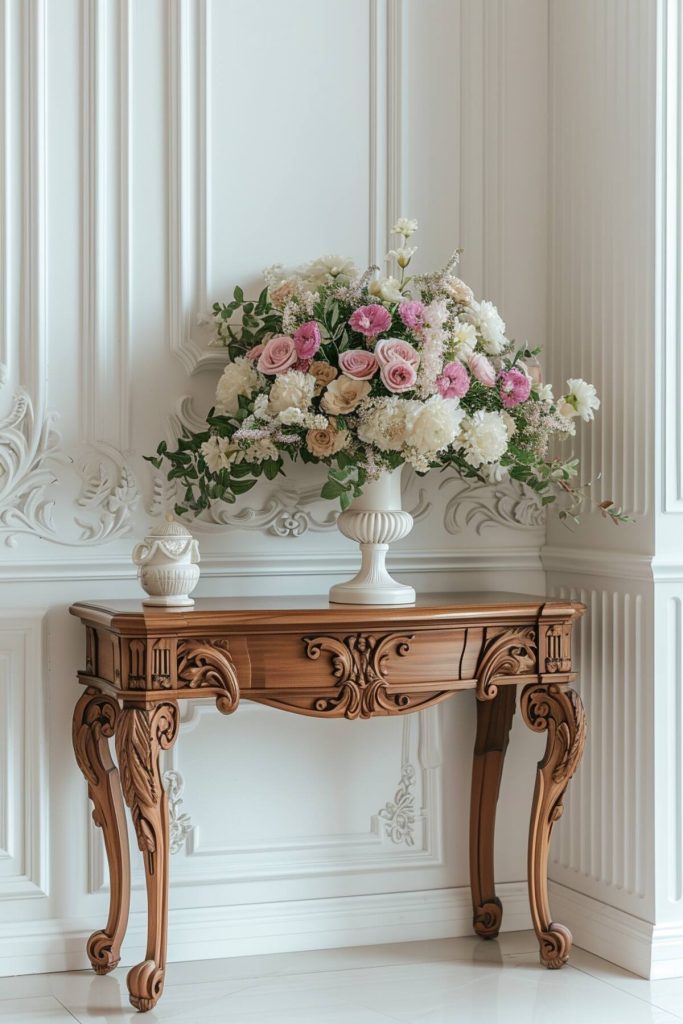 A vintage console table with a white ceramic vase with a floral arrangement