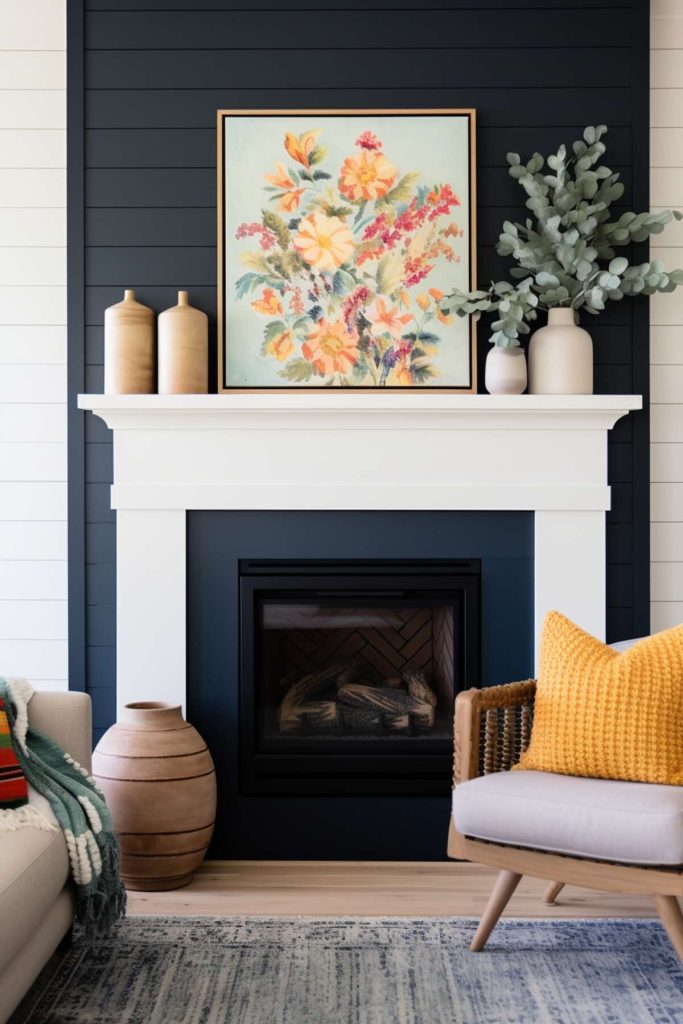 a living area with a black fireplace with the crisp contrast of a white mantel surround, decorated with a eucalyptus plant in a matching white vase