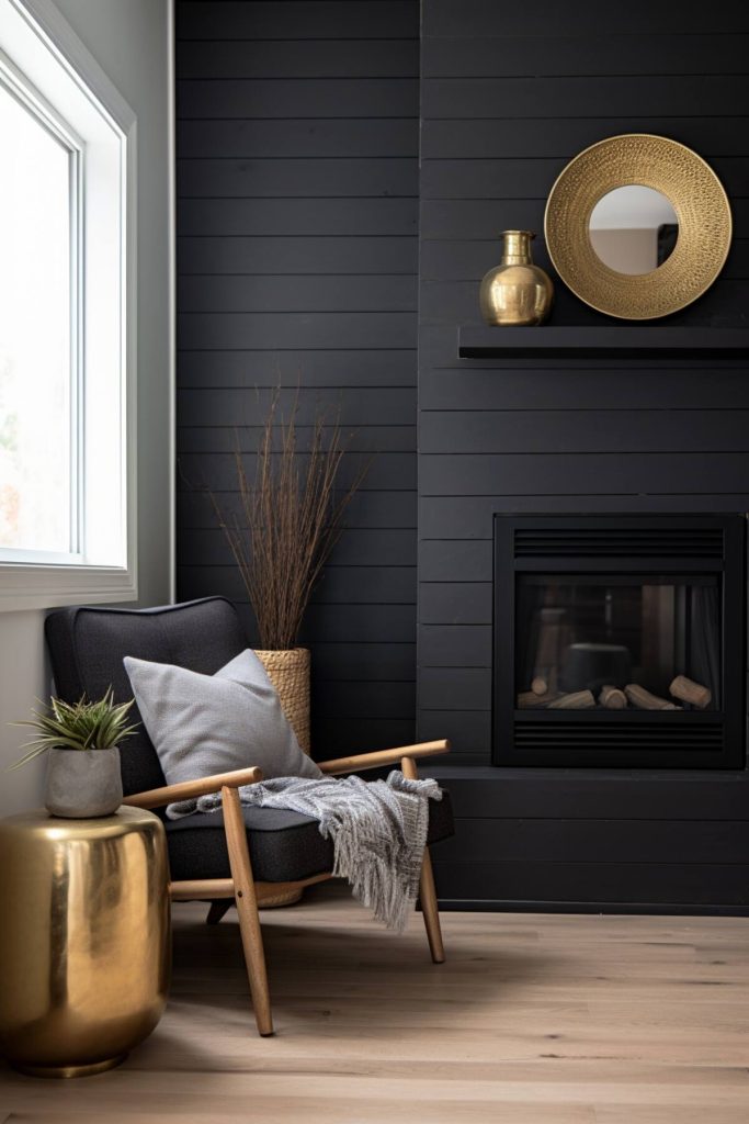 a living area with a black fireplace and a black mantel with a single gold vase paired with a rattan mirror