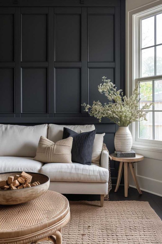 If you want your living room to embody modern elegance, choose a black wall with flat paneled panels. This design creates a clean and streamlined look while adding a touch of flair. 