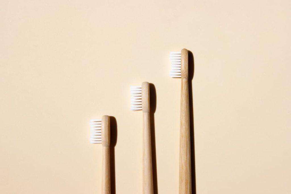 Bamboo toothbrushes on a light background. Say no to the plastic concept. Top view, copy space, flatlay.