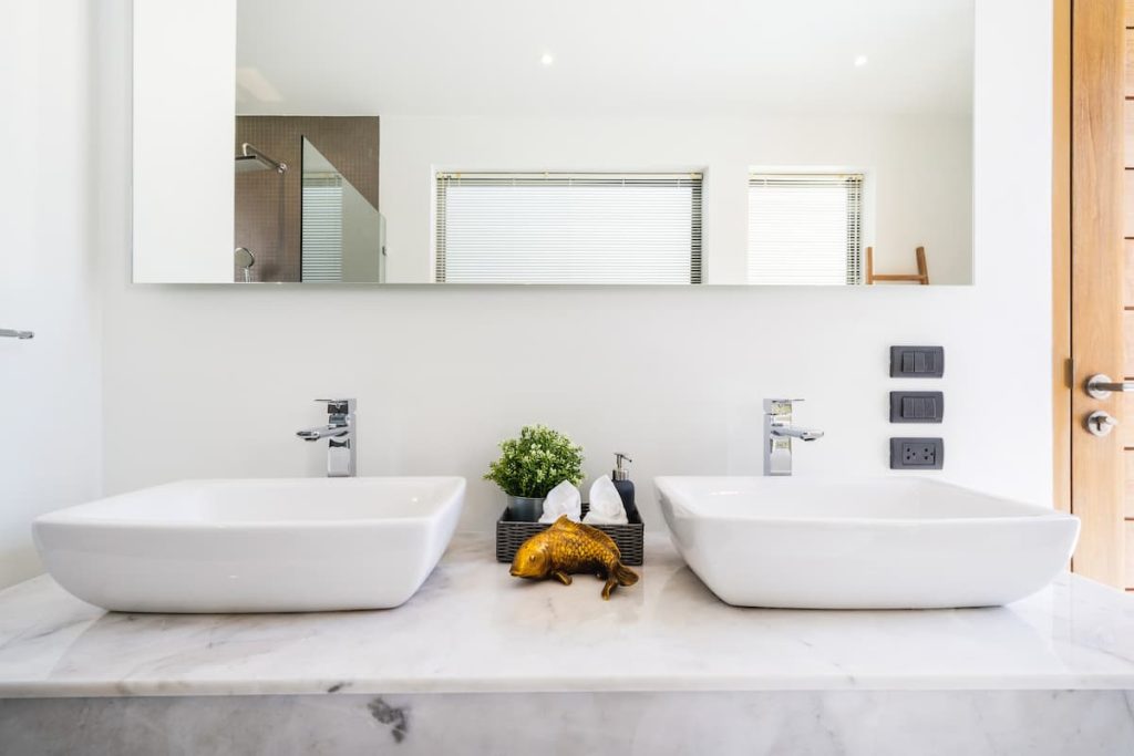 Modern bathroom, sink, shower and bathtub in a luxury villa