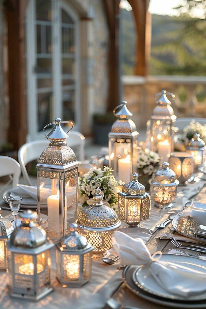 Outdoor table setting with silver and white decorations and shimmering metal lanterns