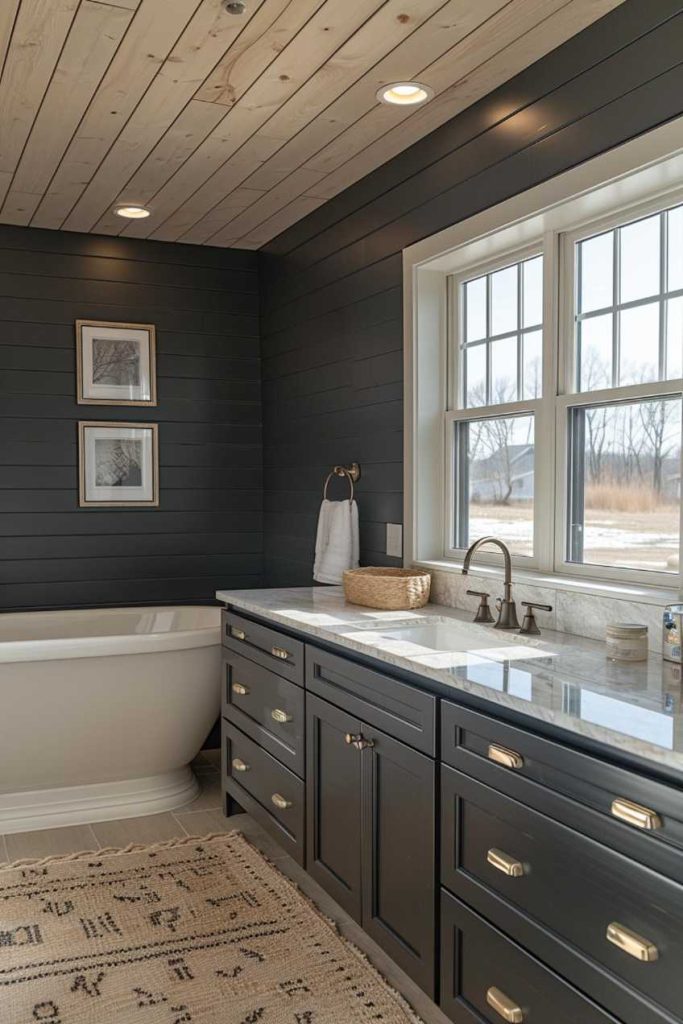 Black is a great option if you want to create a bathroom that is elegant and sophisticated. In this laundry room, matte black shiplap provides a dramatic backdrop for marble countertops and chic decor.