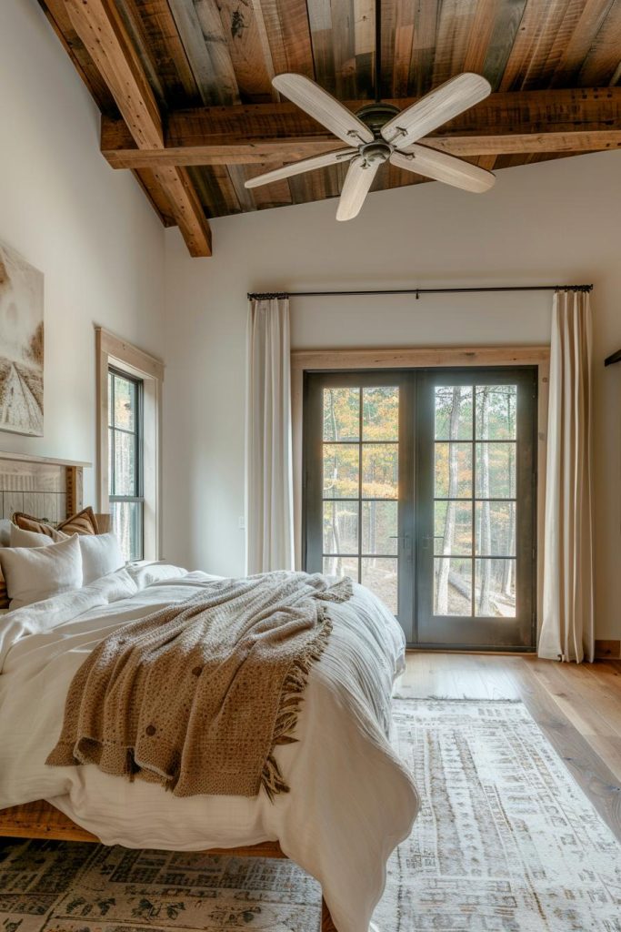 A rustic ceiling fan made of wood whirls above them, the wings of which contribute to both air circulation and aesthetics of the bedroom. Everything else in the room is neutral to ensure that the fan bangs and is guaranteed both shape and function.