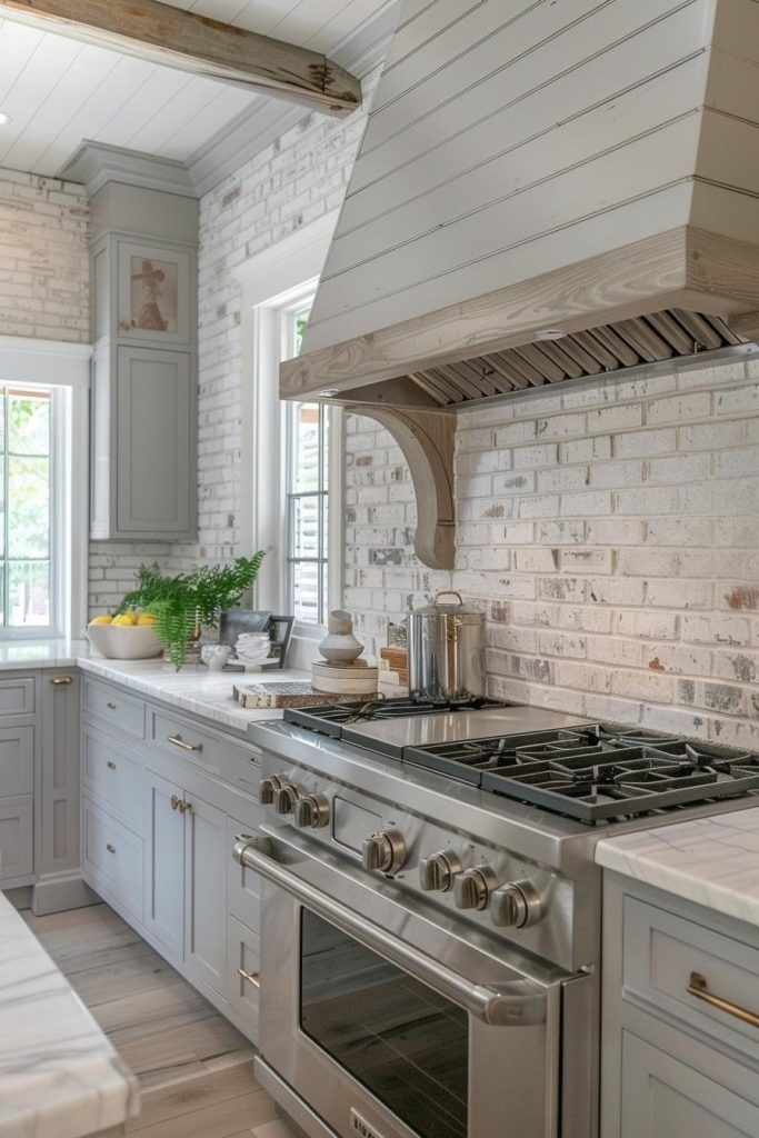 A white brick backsplash in the background adds a touch of country elegance to the kitchen and complements the cool gray cabinets with a touch of farmhouse charm.