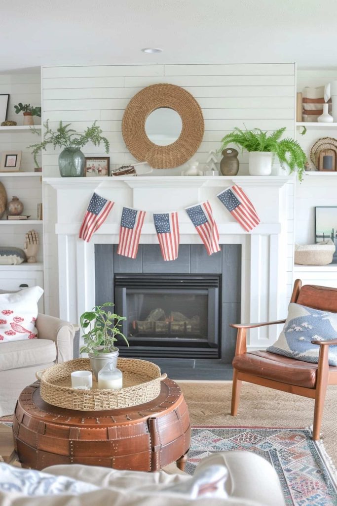 A living room has a white Shiplap fireplace that is decorated with small flags that resemble the American flag. A circular basket mirror hangs over the fireplace with potted plants and decorative objects. A leather armchair, a wooden coffee table and a soft couch.