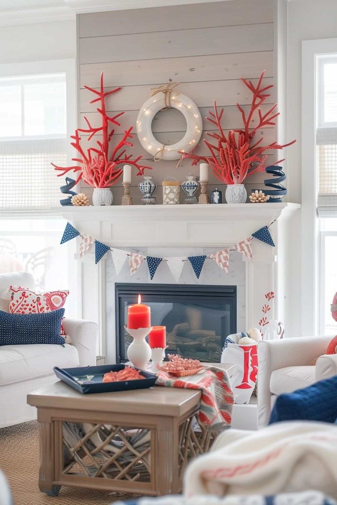 A living room with a coastal topic with red coral decorations on a white fireplace. The coat also shows a white wreath and small decorative objects. The room has white furniture with red accents, a wooden coffee table with decor and a blue and white AMD on the fireplace.