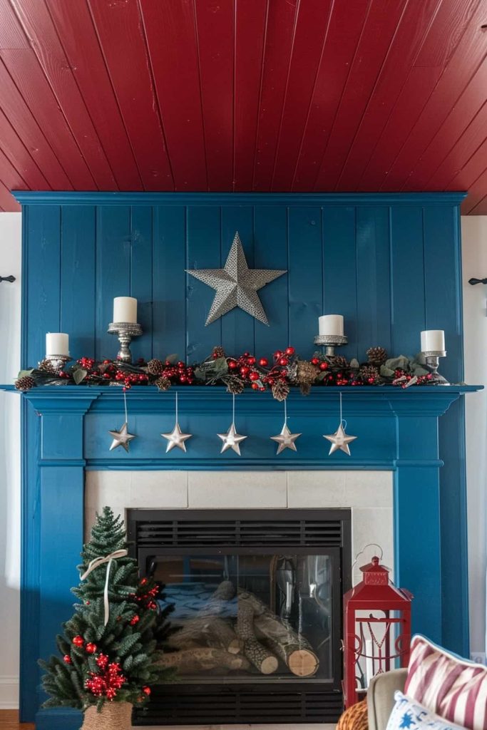 A festive fireplace exhibition with a blue coat that is decorated with candles, pine cones and red berries. A silver star hangs at the top and four silver star decorations dangle at the bottom. A small Christmas tree is at the side, with a red lantern nearby and a red blanket over it.