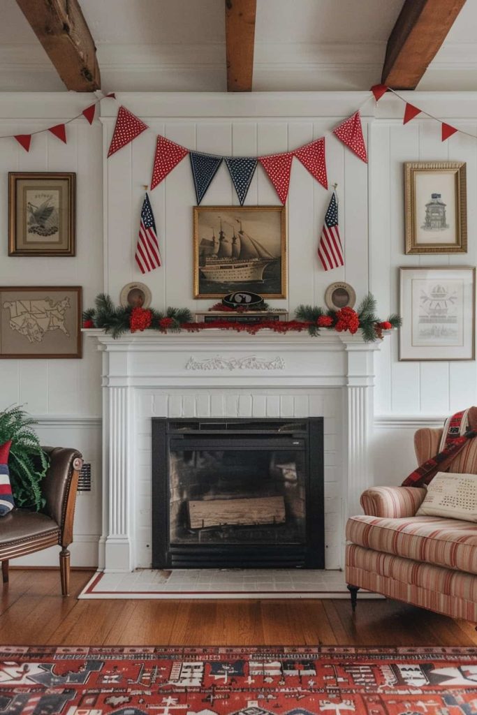 A living room has a white fireplace that is decorated with a garland and two American flags. Above the coat there is a ship painting and red, white and blue colored. The room includes framed art, a striped armchair and a green chair with wooden beams on the ceiling.