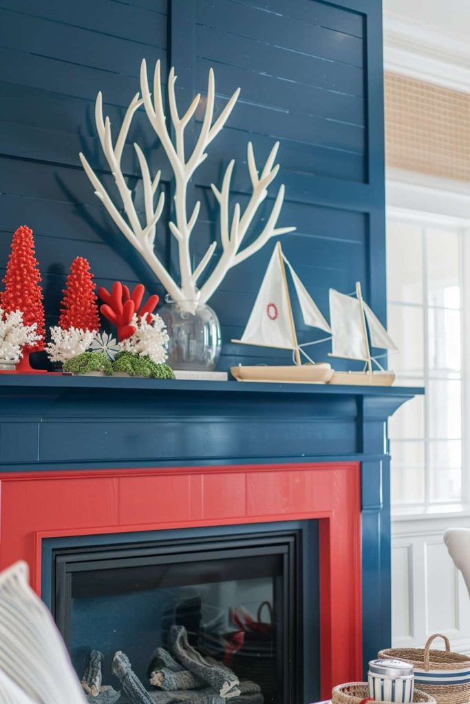 A fireplace decorated in a nautical topic. The marine blue coat has white coral sculptures, red Christmas tree decorations and white sailboat models. The fireplace environment is painted red, and a basket shell with striped objects is on the stove.