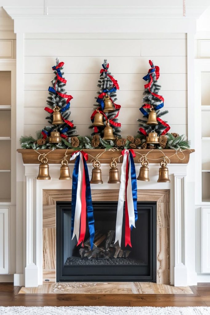 A festive chimney coat that is decorated with golden bells, red, white and blue ribbons and green. Three small Christmas trees, which are decorated with similar ribbons and bells, sit on the fireplace. The fireplace below shows a natural wood and a black finish.